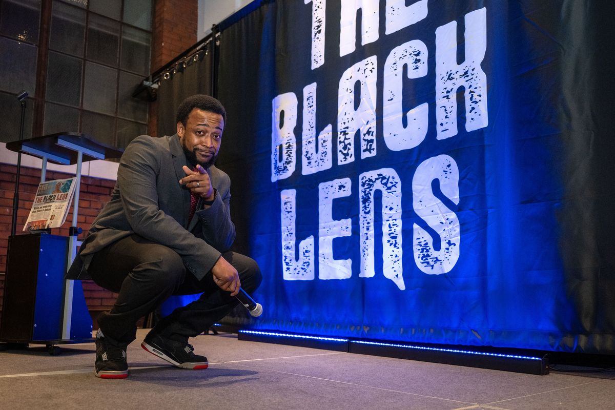 Master of ceremonies for the night and The Black Lens board member Michael Bethely strikes a pose on stage before speaking to the large crowd gathered at the relaunch party for The Black Lens newspaper on Feb. 2 at the Steam Plant rooftop event center. (COLIN MULVANY/THE SPOKESMAN-REVIEW)