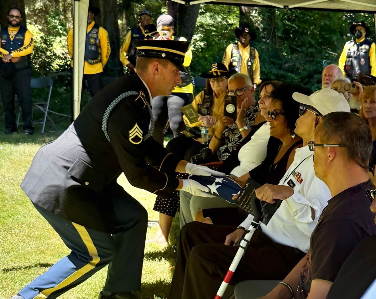 The Fairchild Honor Guard presents the American flag to Sandra Freeman, grandaughter of the late Isham A. Mitchell.  (Courtesy)