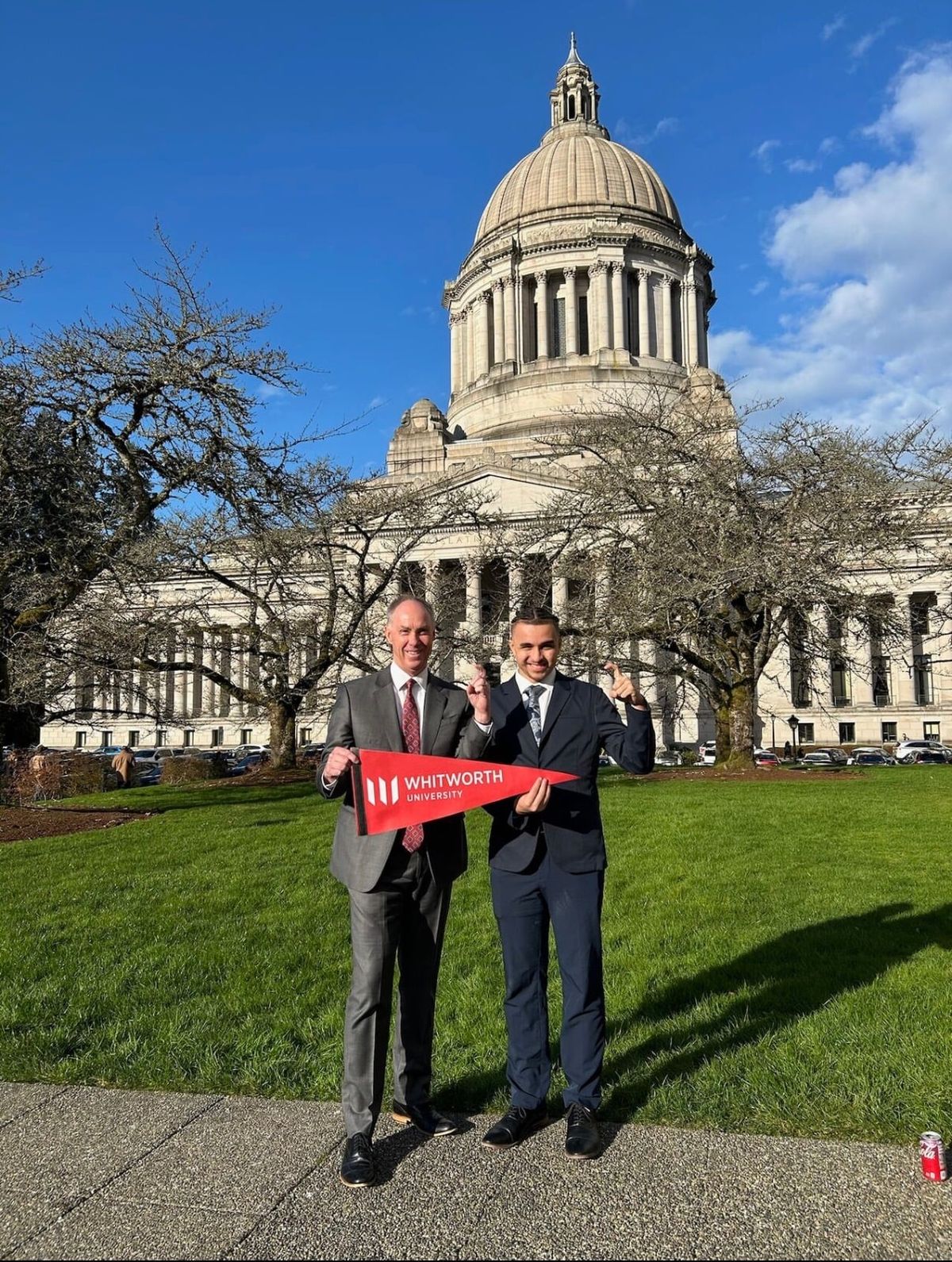 Whitworth University student Vernon Glass, right, stands with Whitworth President Scott McQuilkin outside the Washington state Capitol. (Courtesy)
