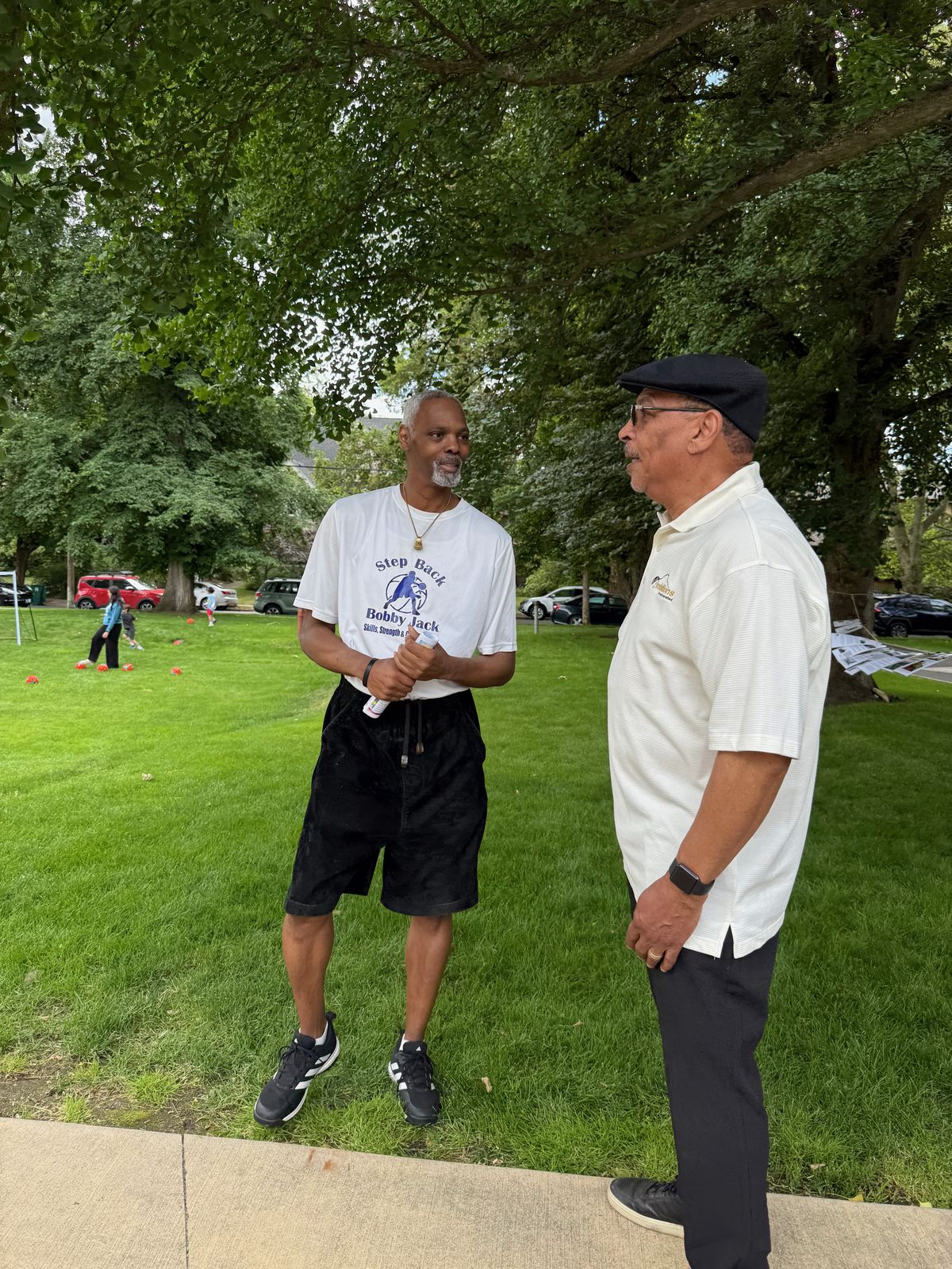Bobby Jack Sumler (left) catches up with Billy Poindexter (right) during the Our Stories event at the Northwest Museum of Arts and Culture, celebrating community and Black roots in Spokane. (April Eberhardt/The Black Lens)