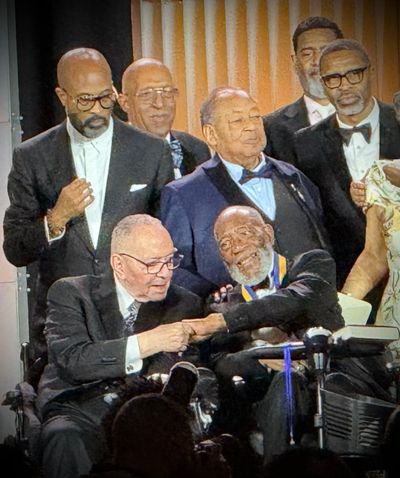 Surrounded by family, friends, the NAACP Board of Directors, and NAACP President Derrick Johnson, the Rev. Jeremiah Wright and the Rev. Dr. Amos C. Brown shared a moving moment of endearment and solidarity at the 117th NAACP National Convention in Chicago after Brown, the NAACP's newest Spingarn Medal recipient, invited Wright to join him on stage during his acceptance remarks.  (April Eberhardt/The Black Lens)