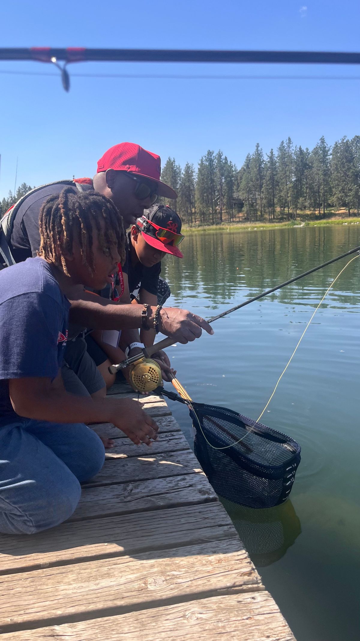 Cpt. Lael Johnson helps Titus and Dezyre with casting.  (Courtesy)